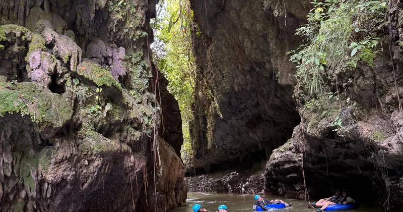 Tubers drifting through the Tanamá canyon in helmets, near Arecibo